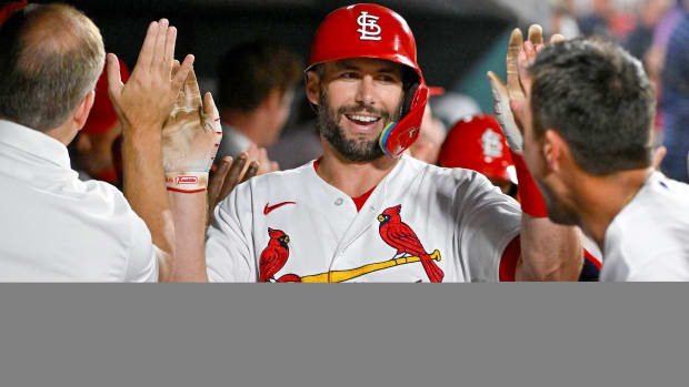 Paul Goldschmidt high fives his teammates after hitting a home run.